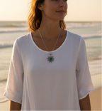 925 oxidised silver sun necklace with green onyx stone worn with white linen dress at beach — boho coastal silver jewelry by CHAKORE
