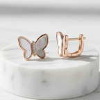 925 Sterling Silver Rose Gold Butterfly Stud Earrings – Front and Side Angle View on Marble Pedestal