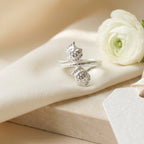 Double tulip flower wrap 925 Sterling Silver ring by CHAKORE with a white flower on a beige surface