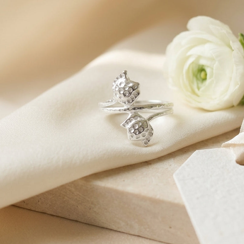 Double tulip flower wrap 925 Sterling Silver ring by CHAKORE with a white flower on a beige surface