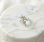 925 silver double tulip flower wrap ring by CHAKORE with a diamond on a marble surface