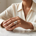 Woman wearing a 925 silver double tulip flower wrap ring by CHAKORE, sitting at a table with a neutral background