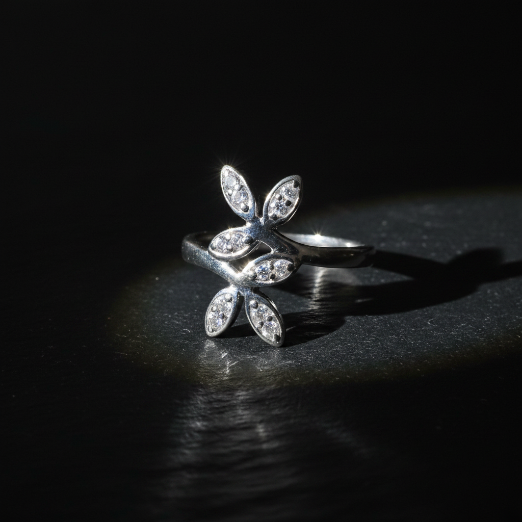 925 sterling silver floral ring with CZ petals on dark slate surface with dramatic rim lighting and shadow play – moody luxury product shot