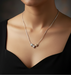 925 silver tri-tone hearts necklace worn at neckline on black dress — pave crystal pendant India