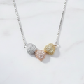 925 silver tri-tone pave hearts necklace by CHAKORE flat lay on white marble — Clara pendant India

