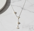 Asymmetric 925 silver Necklace by CHAKORE with pearls and GinkgoFan leaves pendants on Flat Lay on Marble