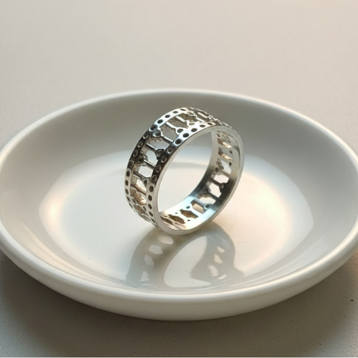 925 sterling silver wide band ring with open lattice design and pavé-set cubic zirconia stones – CHAKORE – back side 45 degree ceramic dish. Modern minimalist silver jewellery, architectural wide band ring, high-polish everyday wear. 