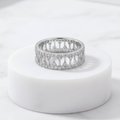 925 sterling silver wide band ring with open lattice design and pavé-set cubic zirconia stones – CHAKORE – Marble Flat Lay. Modern minimalist silver jewellery, architectural wide band ring, high-polish everyday wear.