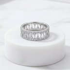 925 sterling silver wide band ring with open lattice design and pavé-set cubic zirconia stones – CHAKORE – Marble Flat Lay. Modern minimalist silver jewellery, architectural wide band ring, high-polish everyday wear.