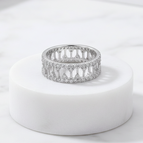 925 sterling silver wide band ring with open lattice design and pavé-set cubic zirconia stones – CHAKORE – Marble Flat Lay. Modern minimalist silver jewellery, architectural wide band ring, high-polish everyday wear.