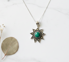 925 sterling silver oxidised sun necklace with green onyx flat lay on white marble — handcrafted silver jewelry by CHAKORE

