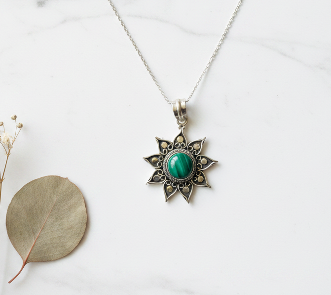 925 sterling silver oxidised sun necklace with green onyx flat lay on white marble — handcrafted silver jewelry by CHAKORE

