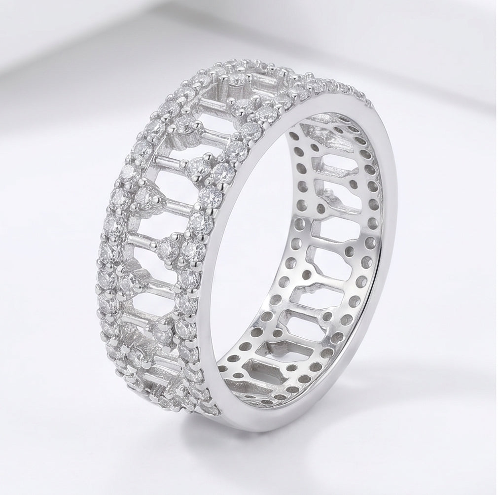 925 sterling silver wide band ring with open lattice design and pave-set cubic zirconia stones – CHAKORE – 45 angle standing. Modern minimalist silver jewellery, architectural wide band ring, high-polish everyday wear.