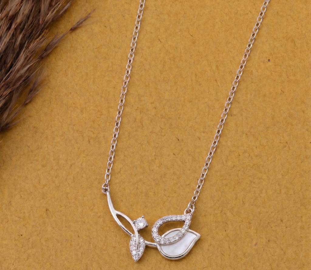 925 Sterling Silver asymmetrical leaf necklace by  CHAKORE on a mustard background