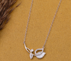 925 Sterling Silver asymmetrical leaf necklace by  CHAKORE on a mustard background