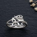 925 botanical wrap Silver ring by CHAKORE with floral design on a dark textured surface