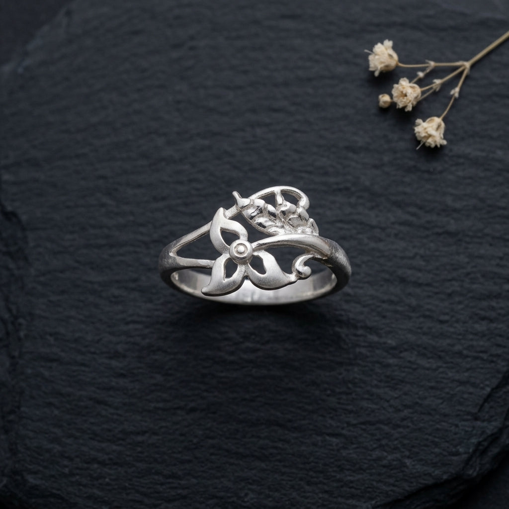 925 botanical wrap Silver ring by CHAKORE with floral design on a dark textured surface