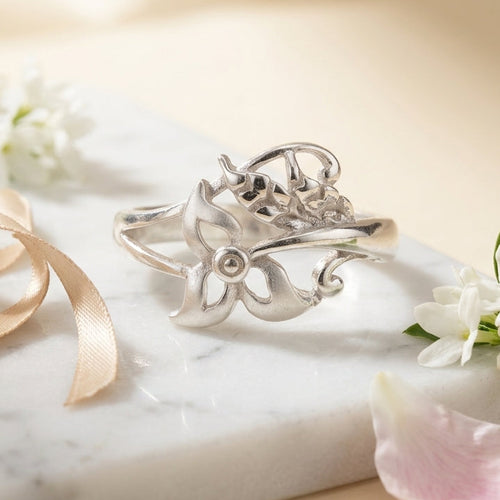 925 sterling Silver ring with floral design with matte finish on a marble surface with flowers and ribbon by CHAKORE