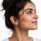 A close-up side profile of a woman wearing a 925 pure Silver small round stud earring by Chakore with a silver textured center and a halo of clear stones, set against a plain white background.