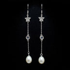 A pair of 925 sterling silver dangle earrings by Chakore with star-shaped charms, small round clear stones, and teardrop-shaped white pearls, displayed against a solid black background.