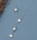 Asymmetric 925 silver Necklace by CHAKORE with pearls and GinkgoFan leaves pendants on a blue background