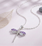 A close-up photograph of a standalone 925 sterling silver dragonfly pendant featuring intricate purple and soft blue segmented wings. The high-polish pendant features a smooth top loop, resting gracefully on a soft light lavender surface. Minimalist Indian D2C jewelry, nature-inspired charm, everyday modern styling.

