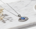 Modern Mystic Evil Eye Oval 925 Silver Pendant flat lay on white marble, minimalist luxury product photography