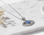 Modern Mystic Evil Eye Oval 925 Silver Pendant flat lay on white marble, minimalist luxury product photography