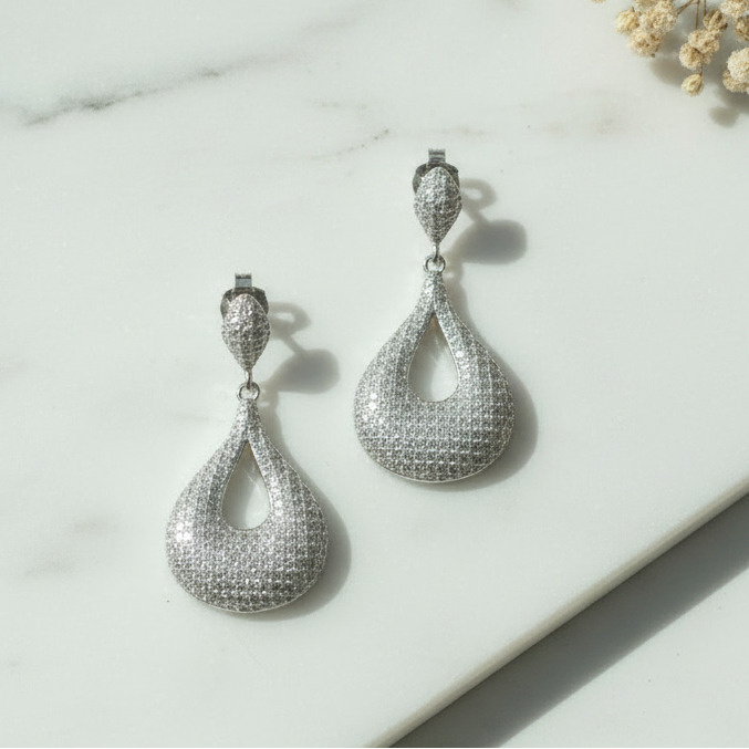 Sizzling party drops 925 silver earrings on white marble with natural props
