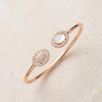 Aura Rose Dual Eclipse bracelet flat lay on ivory stone