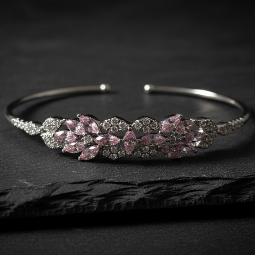Blush Bloom Cuff 925 sterling silver bangle bracelet with blush pink marquise zirconia floral cluster, flat lay on dark slate