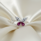 925 Sterling silver butterfly ring with marquise crystal and ruby wings draped on ivory silk fabric with soft window light | CHAKORE

