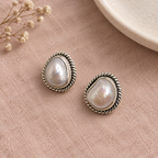 CHAKORE 925 sterling silver studs with genuine baroque freshwater pearls and rope borders on blush linen.