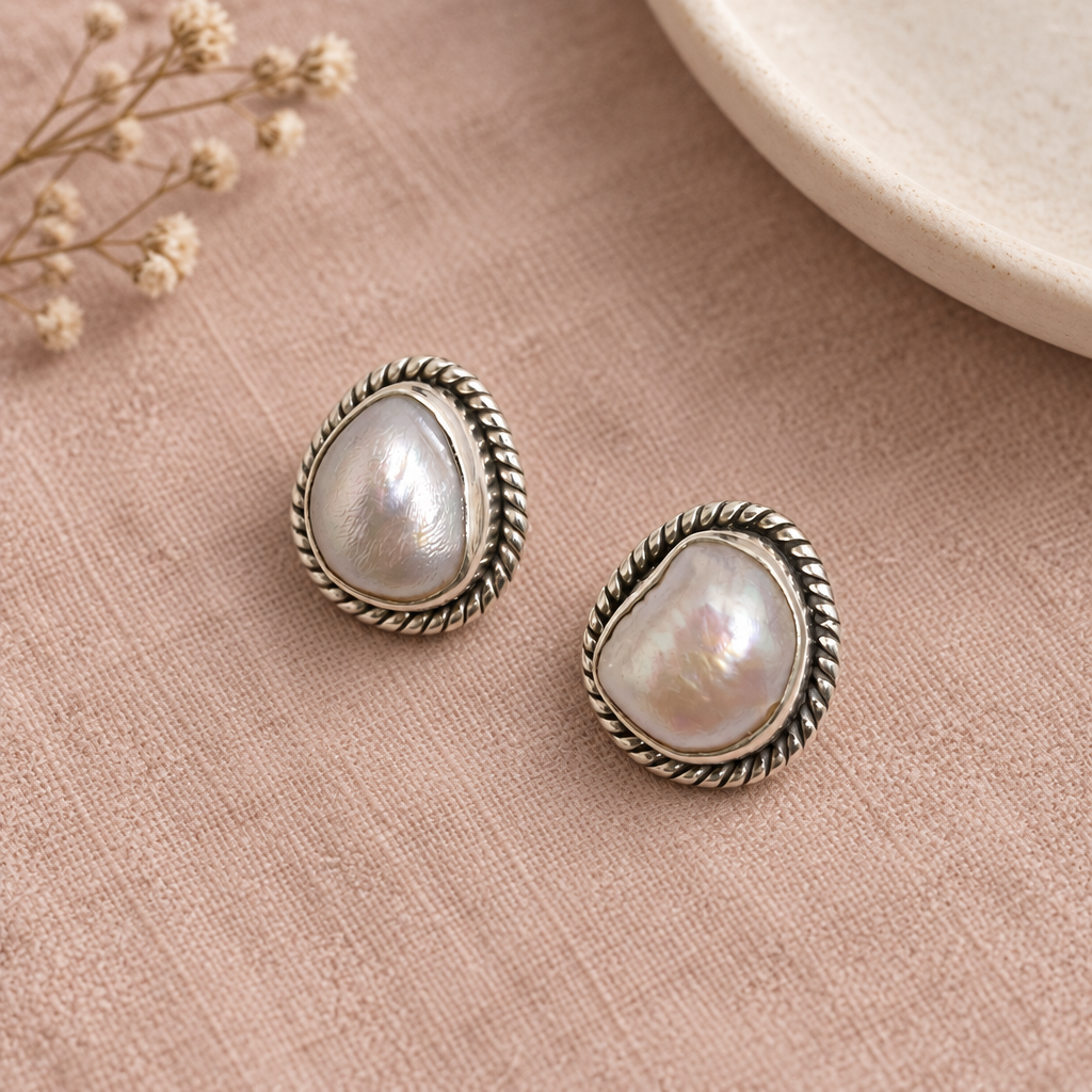 CHAKORE 925 sterling silver studs with genuine baroque freshwater pearls and rope borders on blush linen.