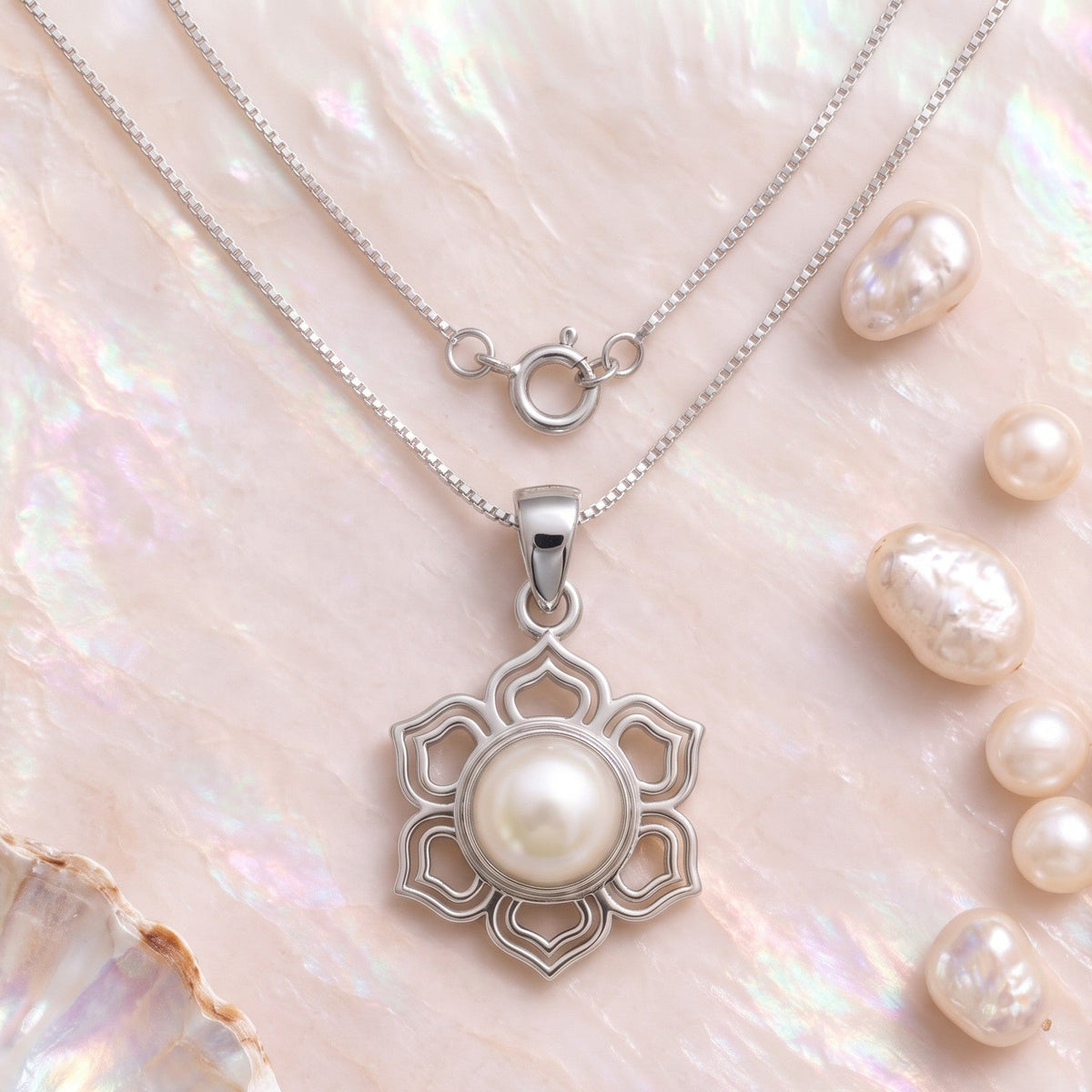 CHAKORE silver jewellery 925 sterling silver lotus original freshwater pearl pendant with a box chain and clasp, displayed beside loose pearls