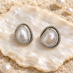 CHAKORE authentic baroque freshwater pearl studs in 925 sterling silver, displayed on a mother-of-pearl shell.