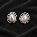 CHAKORE genuine freshwater pearl stud earrings with oxidized 925 sterling silver rope borders on charcoal velvet.