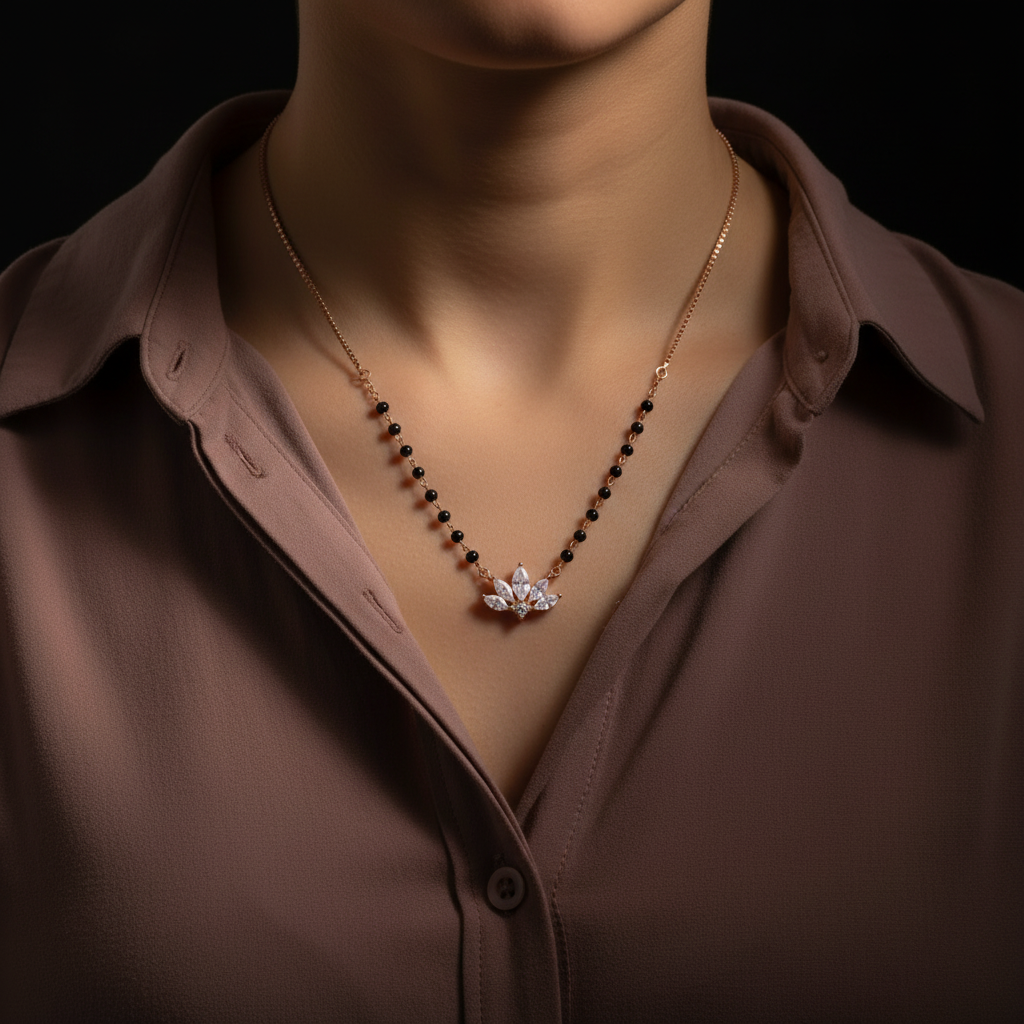 Chakore 925 sterling silver rose gold lotus CZ mangalsutra with black bead chain worn by Indian woman in mauve shirt.