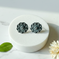 Oxidised 925 silver stud earrings with mandala filigree design on marble surface with minimal props – handcrafted ethnic silver jewelry by CHAKORE

