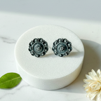 Oxidised 925 silver stud earrings with mandala filigree design on marble surface with minimal props – handcrafted ethnic silver jewelry by CHAKORE

