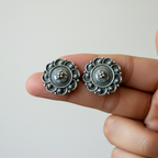 Oxidised 925 silver stud earrings held between fingers for size reference – handcrafted mandala filigree ethnic studs by CHAKORE
