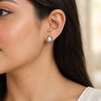 Close-up of CHAKORE real freshwater pearl stud earrings with oxidized 925 sterling silver rope borders, worn on the ear.