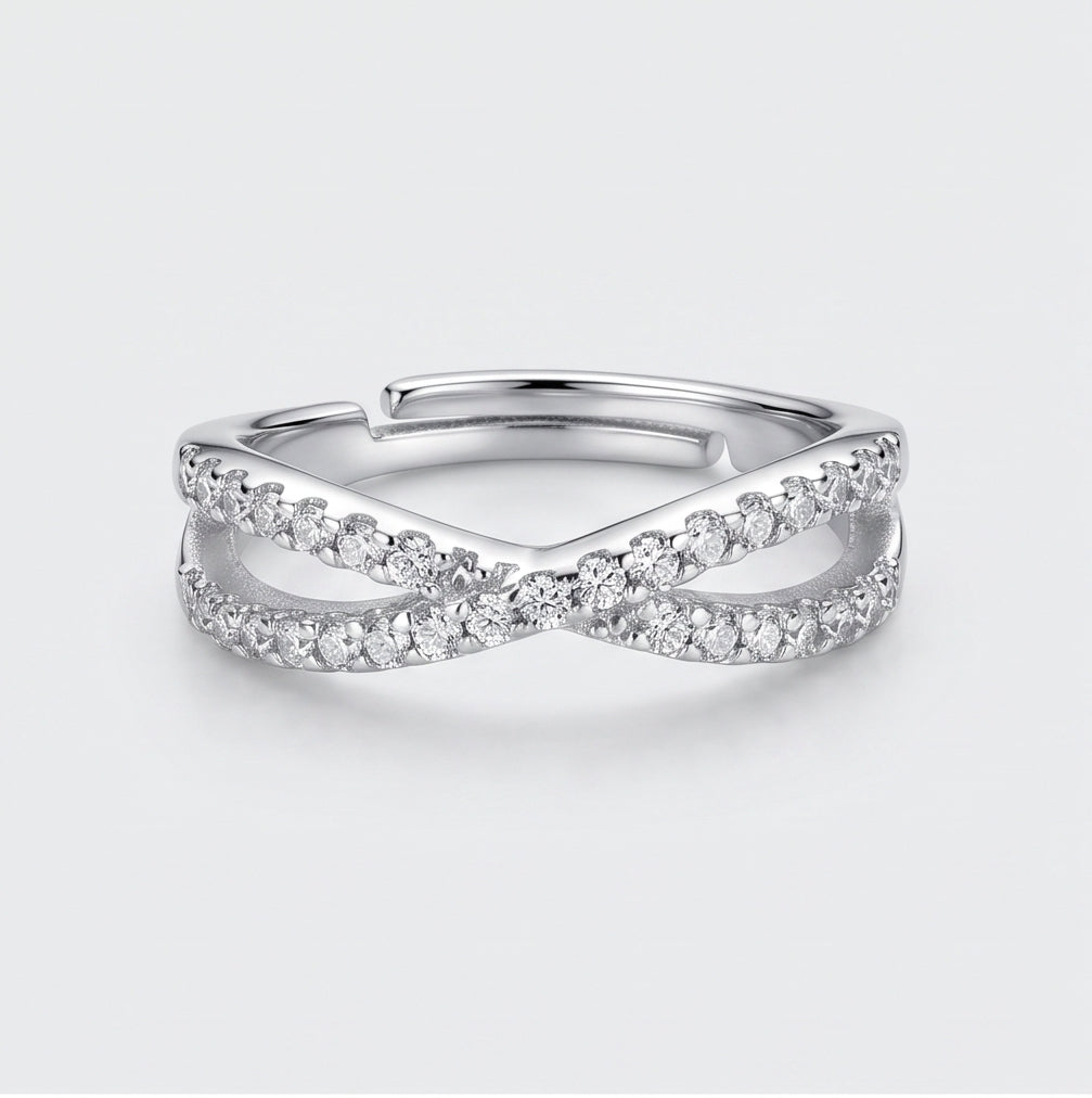 Crossover Infinity 925 Sterling Silver Ring by CHAKORE with Pavé Cubic Zirconia – Adjustable Band Silver ring with diamond accents on a light gray background