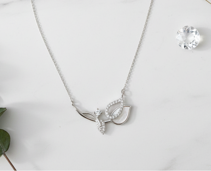 Leaf necklace on marble with props