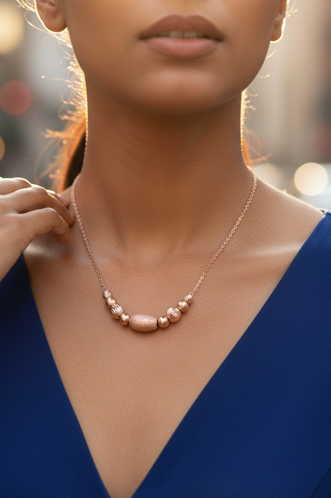 Royal Blue Dress Rose gold beaded 925 silver necklace worn by Indian model in royal blue dress, urban golden hour editorial