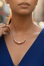 Royal Blue Dress Rose gold beaded 925 silver necklace worn by Indian model in royal blue dress, urban golden hour editorial