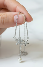 Silver Daisy Pearl Necklace – Held Near Pendant