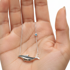 Silver Whale Necklace Resting on Female Model Palm