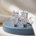 Starry Bloom hoops on a blue ceramic display