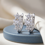Starry Bloom hoops on a blue ceramic display